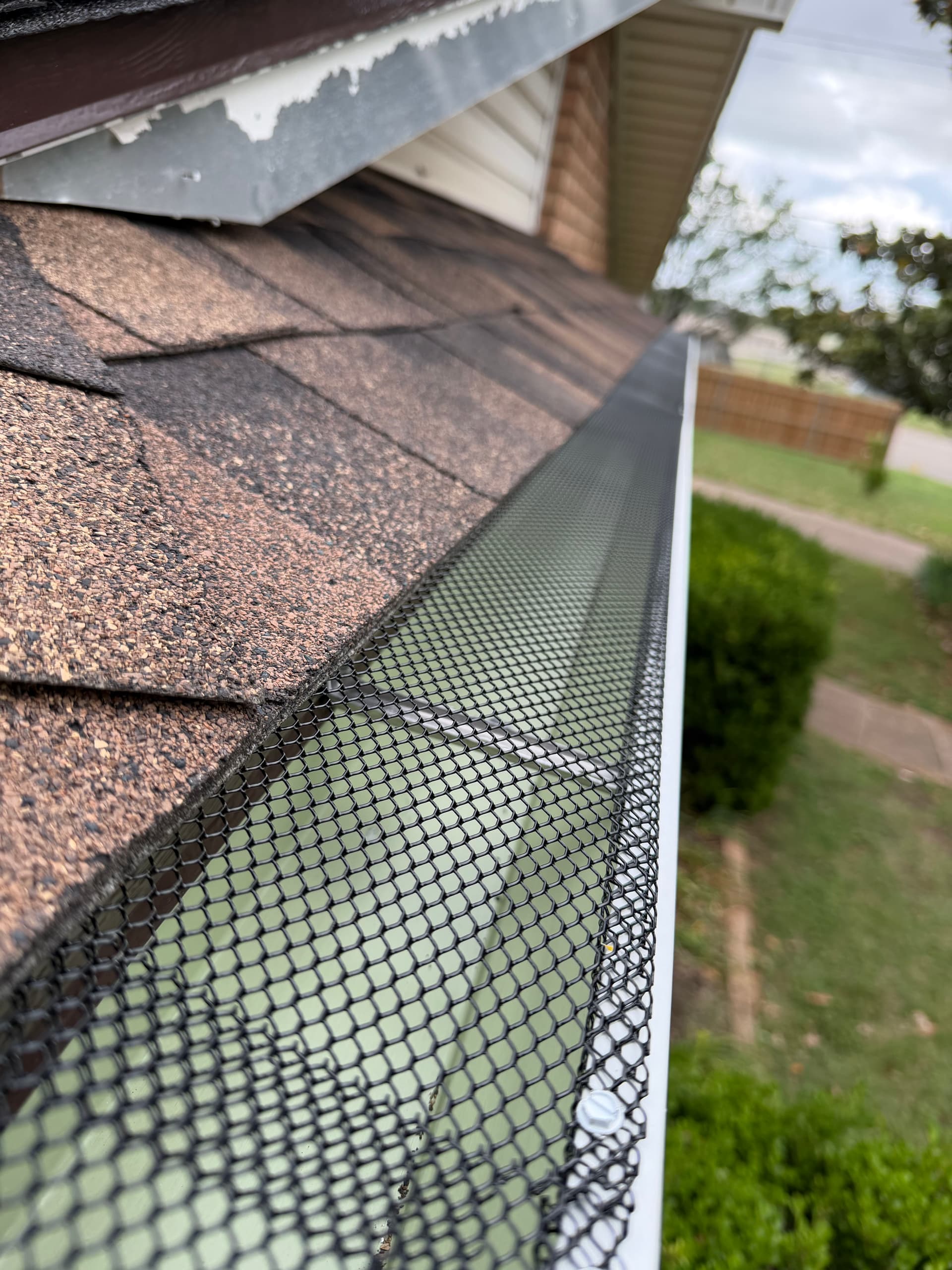 New Seamless Gutters and Gutter Guards Installed on Brick Home image
